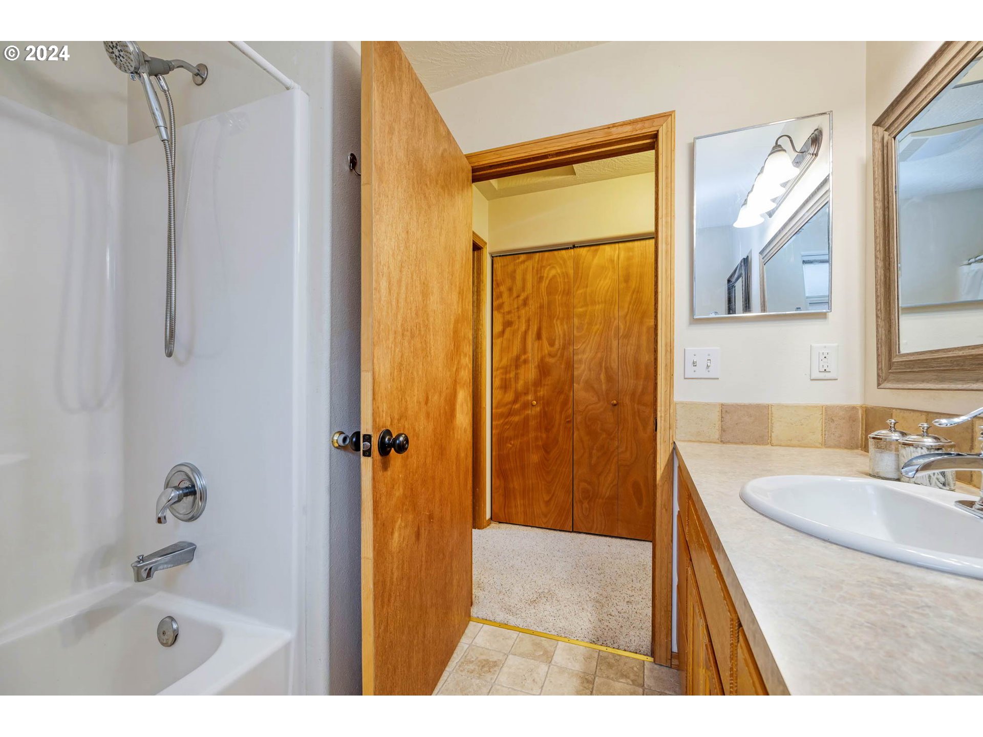 4850 A Street Springfield, OR 97478 - Photo 29 of 40 a bathroom with a sink a mirror and a bathtub