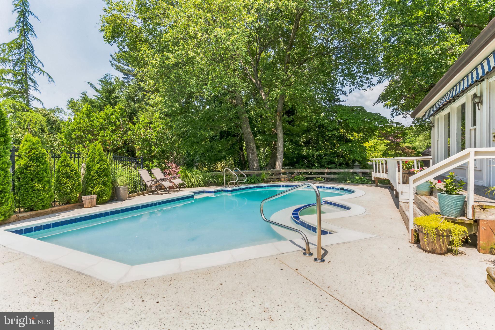 9329 Harvey Road Silver Spring, MD 20910 - Photo 35 of 40 a view of a swimming pool with a lounge chairs