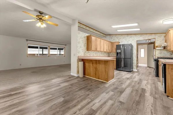 a kitchen with a sink a refrigerator and a stove top oven