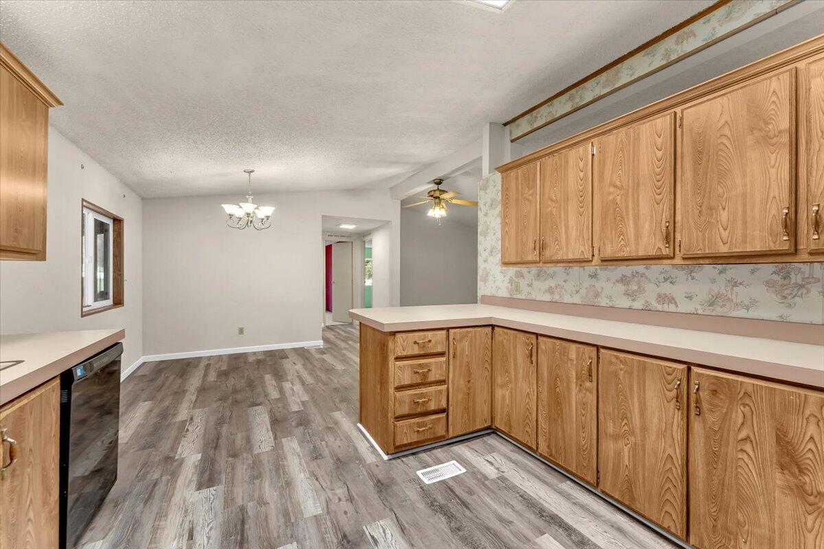 1237 Mountain Shadows Boulevard Redding, CA 96003 - Photo 15 of 34 a view of a kitchen with wooden floor and electronic appliances