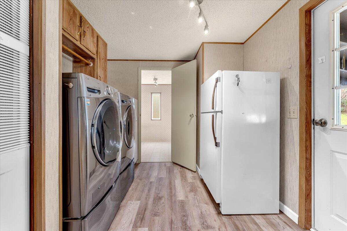 1237 Mountain Shadows Boulevard Redding, CA 96003 - Photo 16 of 34 a view of a hallway with washer and dryer