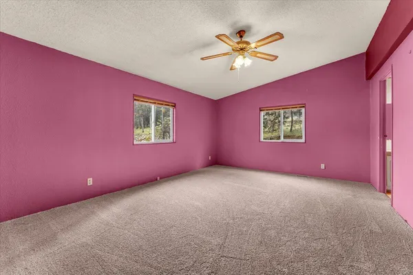 a view of empty room with a fan