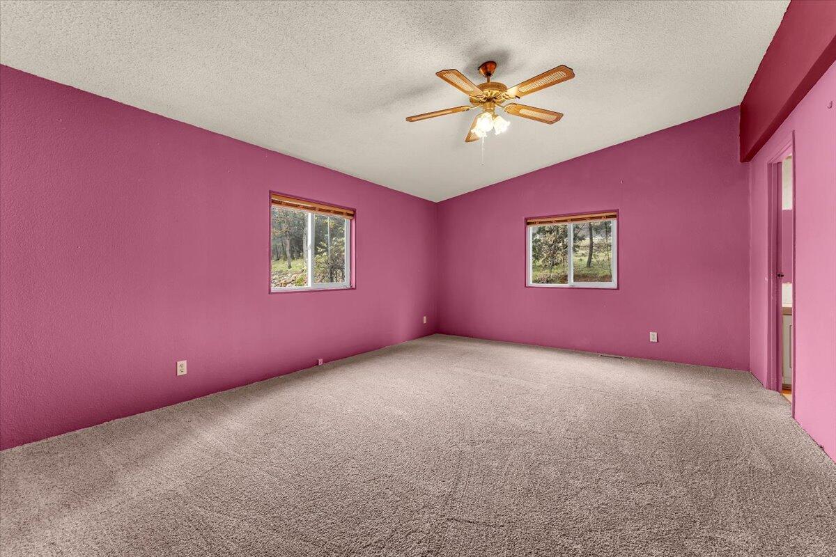 1237 Mountain Shadows Boulevard Redding, CA 96003 - Photo 17 of 34 a view of a livingroom with a ceiling fan and window