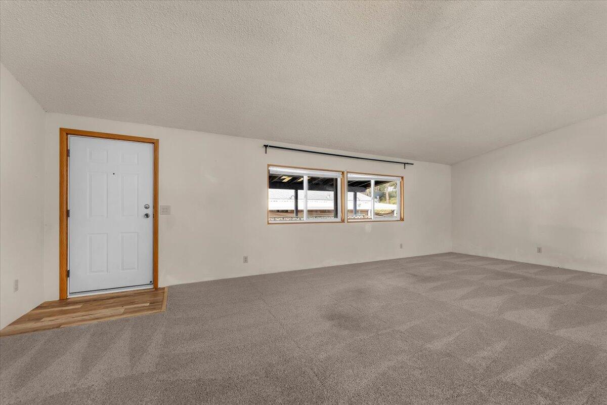 1237 Mountain Shadows Boulevard Redding, CA 96003 - Photo 5 of 34 an empty room with windows