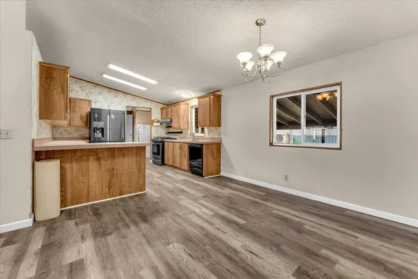 a view of a kitchen with a stove cabinets and wooden floor