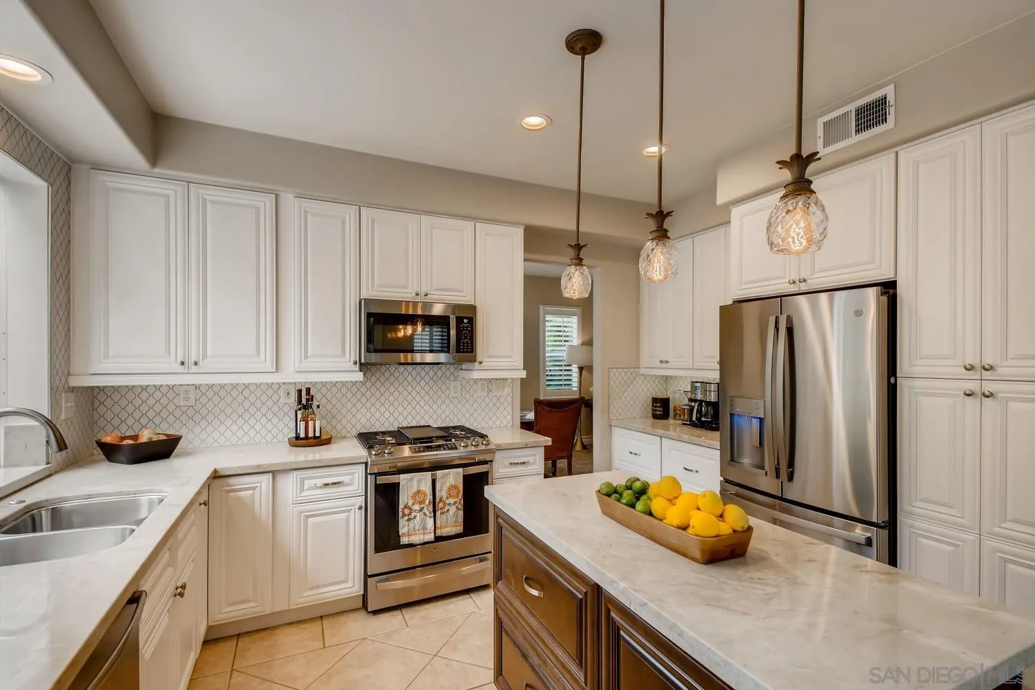 11468 Village Ridge Road San Diego, CA 92131 - Photo 1 of 28 a kitchen with stainless steel appliances a stove a sink a refrigerator a center island and cabinets