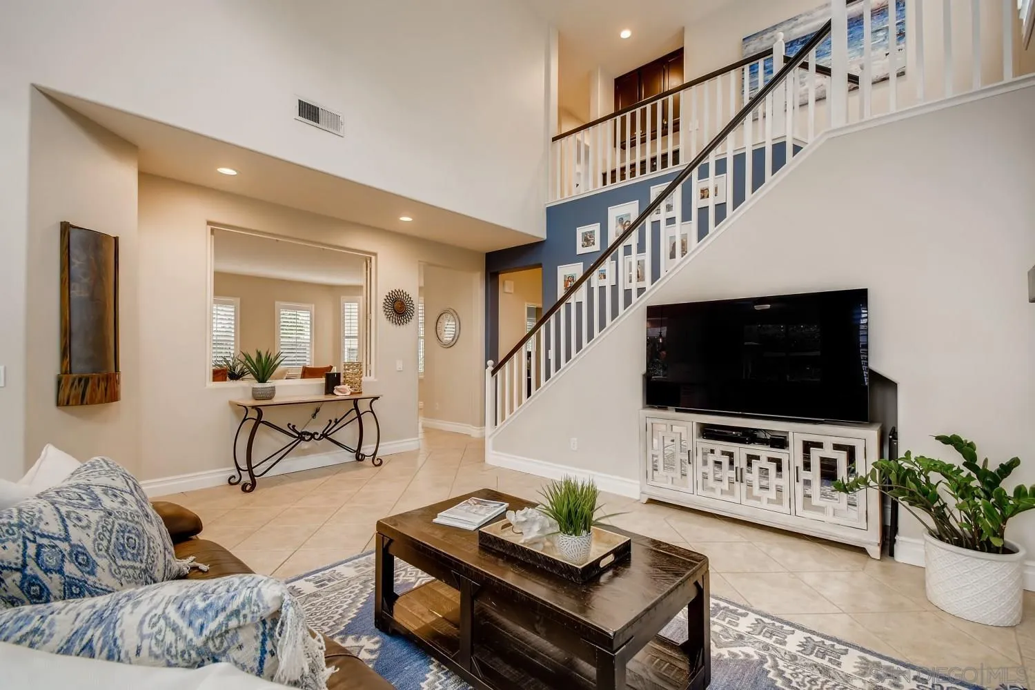 11468 Village Ridge Road San Diego, CA 92131 - Photo 11 of 28 a living room with furniture and a flat screen tv