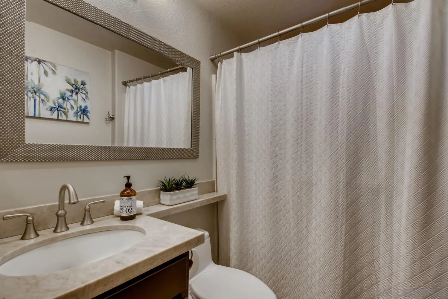 11468 Village Ridge Road San Diego, CA 92131 - Photo 14 of 28 a bathroom with a sink and a mirror