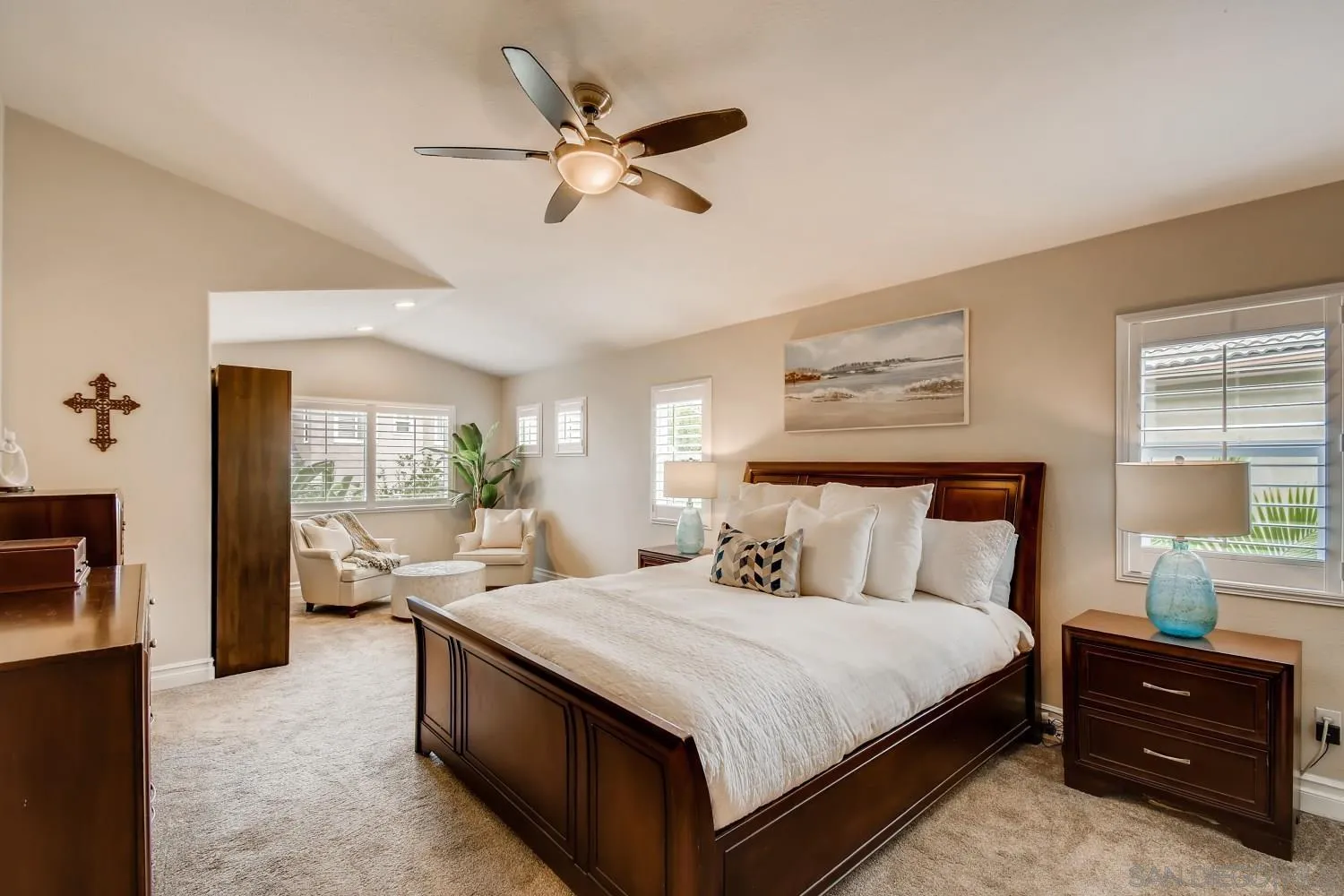 11468 Village Ridge Road San Diego, CA 92131 - Photo 15 of 28 a bedroom with a bed and a chandelier