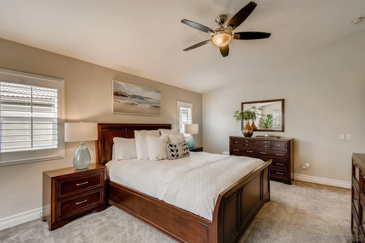 11468 Village Ridge Road San Diego, CA 92131 - Photo 16 of 28 a bedroom with a bed and a chandelier