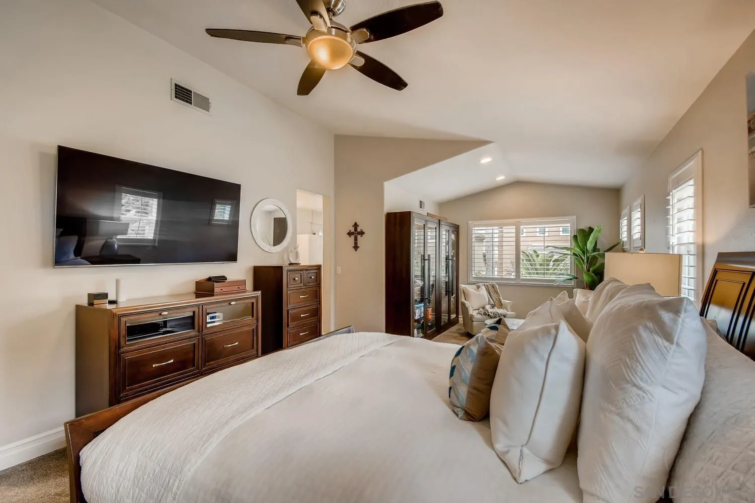 11468 Village Ridge Road San Diego, CA 92131 - Photo 17 of 28 a bedroom with a bed and a flat screen tv