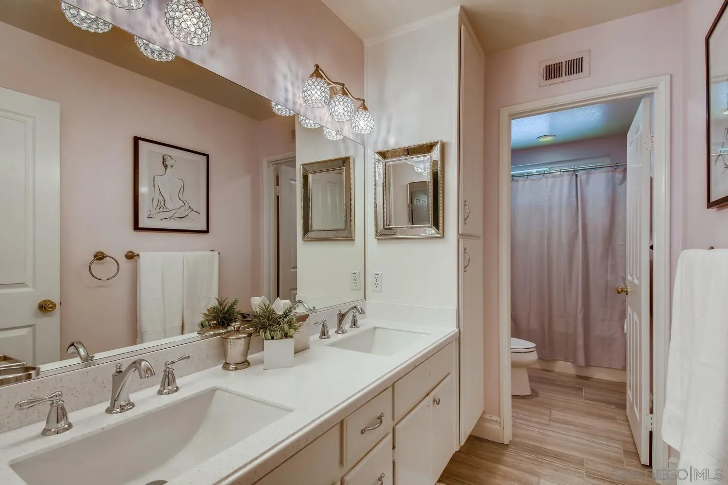 11468 Village Ridge Road San Diego, CA 92131 - Photo 20 of 28 a bathroom with a double vanity sink and a mirror