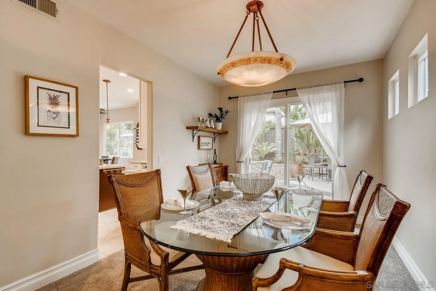 11468 Village Ridge Road San Diego, CA 92131 - Photo 7 of 28 a view of a dining room with furniture wooden floor and a chandelier