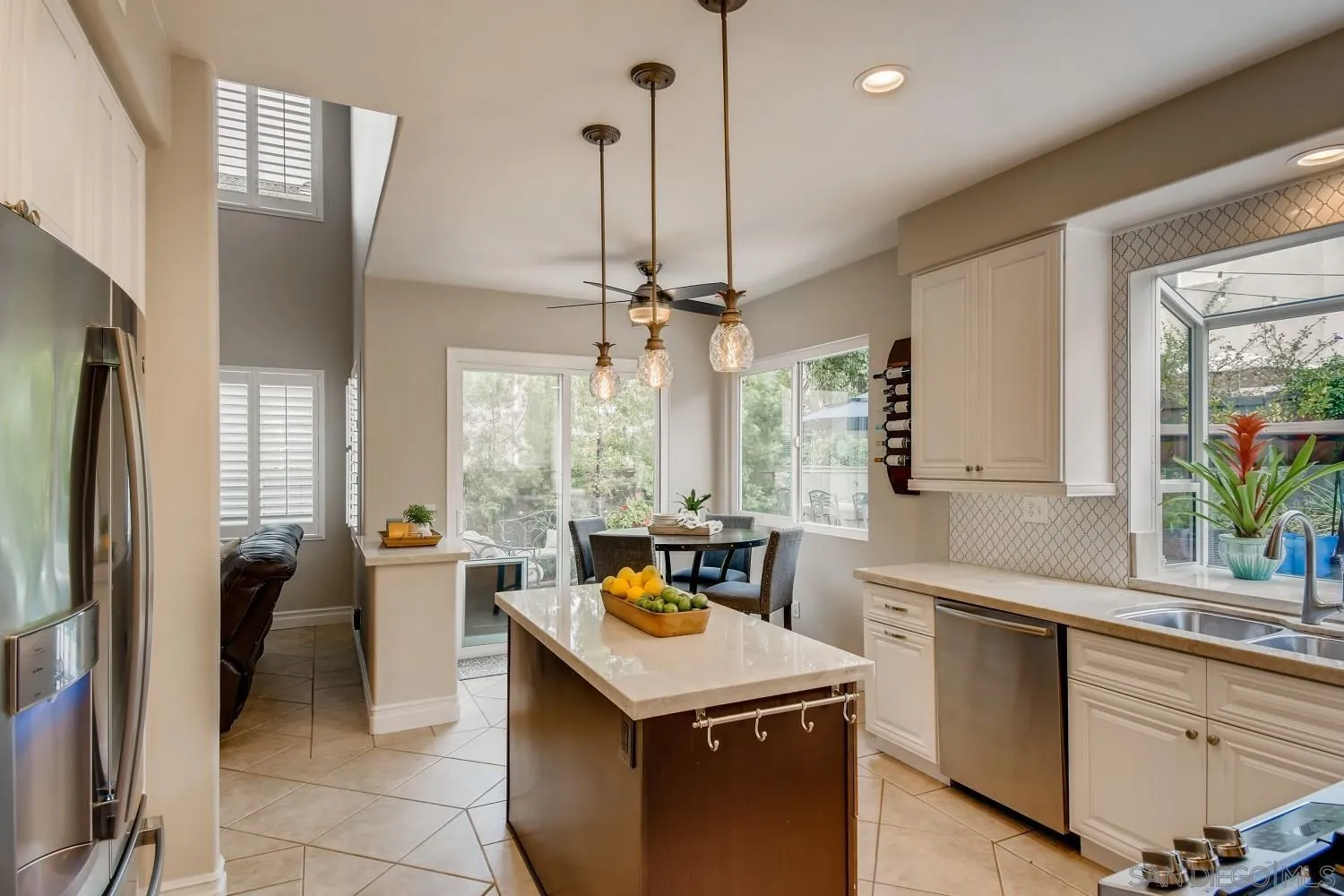 11468 Village Ridge Road San Diego, CA 92131 - Photo 8 of 28 a kitchen that has a lot of cabinets in it and a chandelier