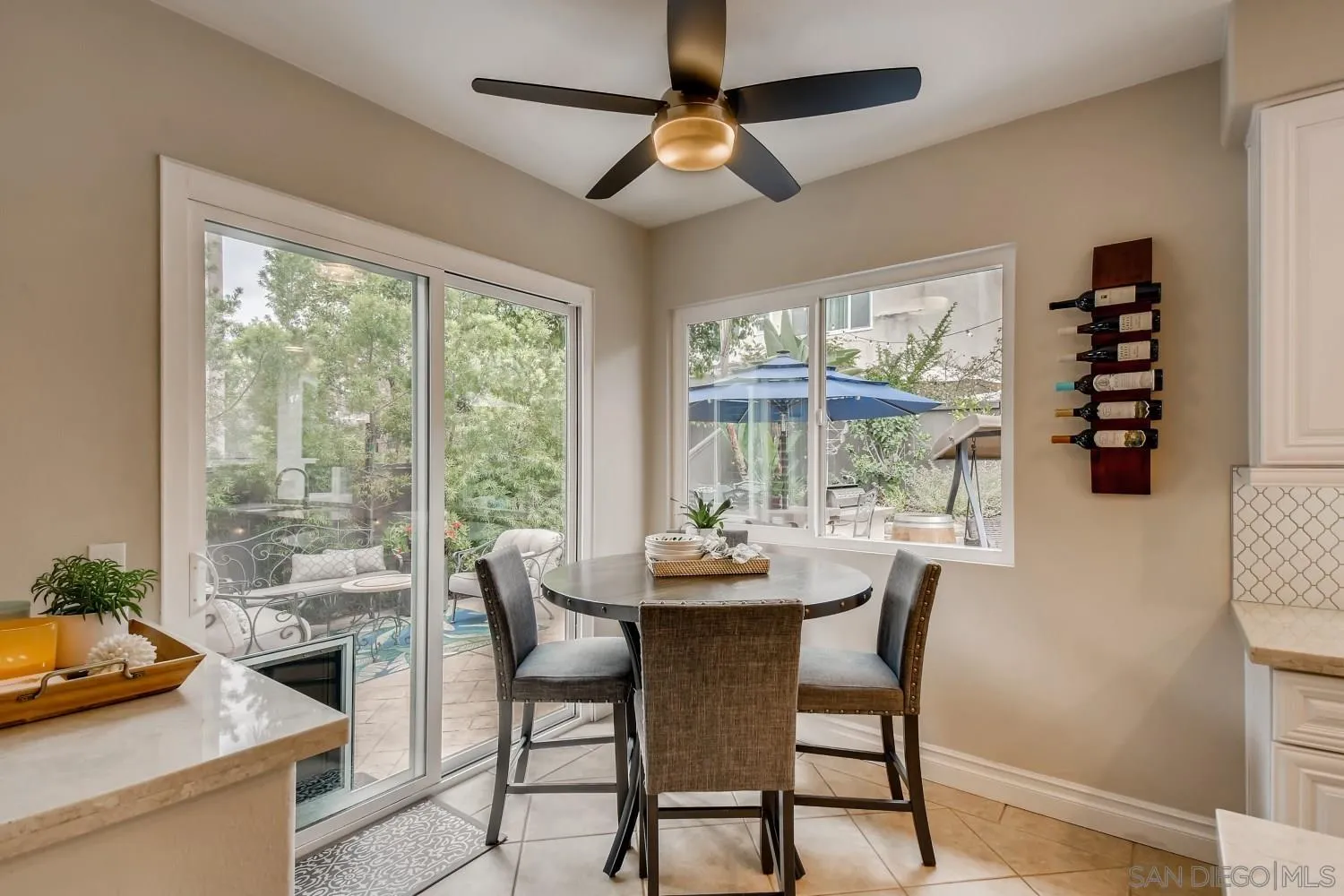 11468 Village Ridge Road San Diego, CA 92131 - Photo 10 of 28 a dining room with furniture a chandelier and wooden floor
