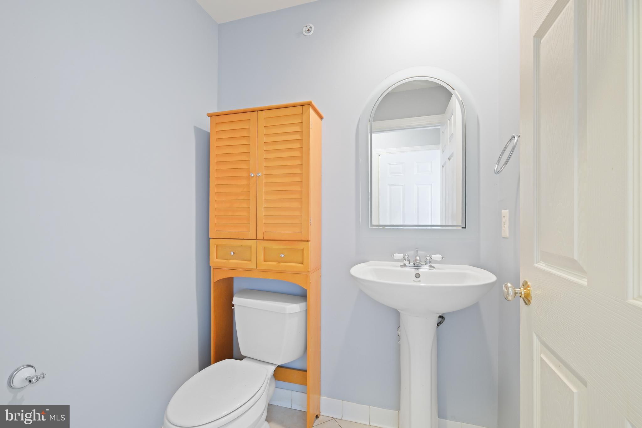 10728 Horde Street Silver Spring, MD 20902 - Photo 20 of 38 a bathroom with a sink and a mirror