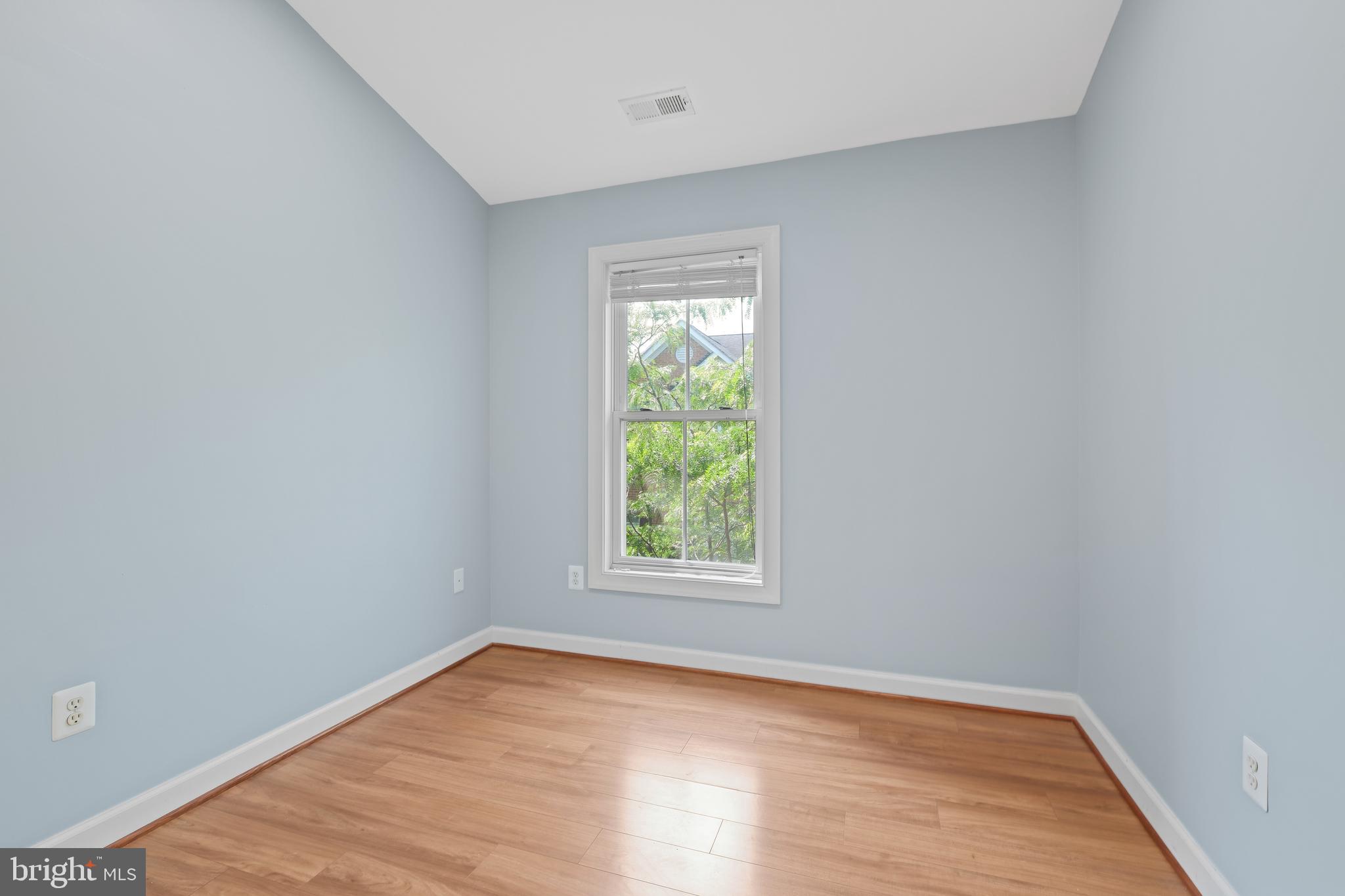 10728 Horde Street Silver Spring, MD 20902 - Photo 25 of 38 wooden floor in an empty room with a window