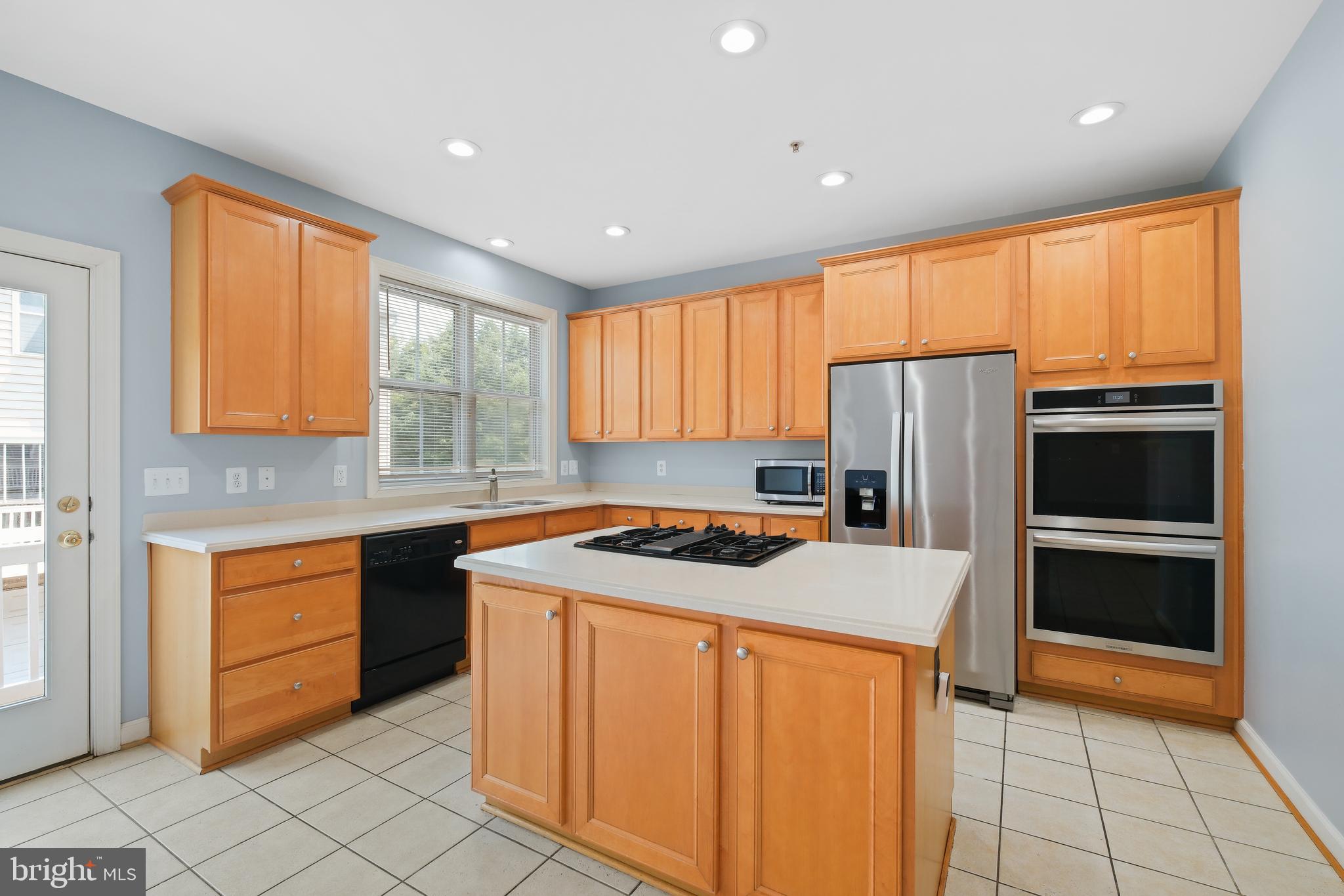 10728 Horde Street Silver Spring, MD 20902 - Photo 5 of 38 a kitchen with stainless steel appliances granite countertop a refrigerator sink and cabinets