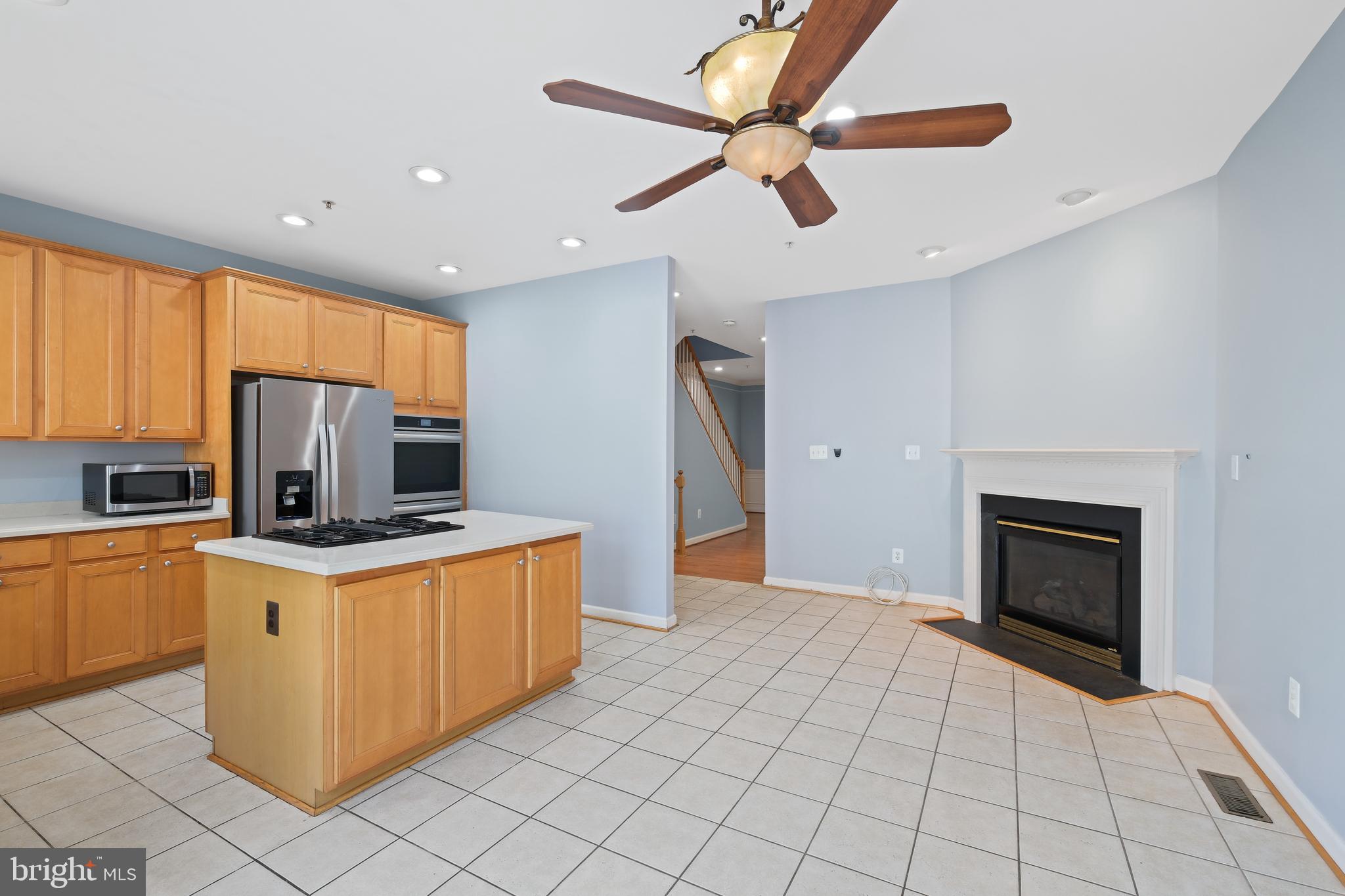 10728 Horde Street Silver Spring, MD 20902 - Photo 7 of 38 a kitchen with stainless steel appliances granite countertop a stove top oven a sink dishwasher and a refrigerator