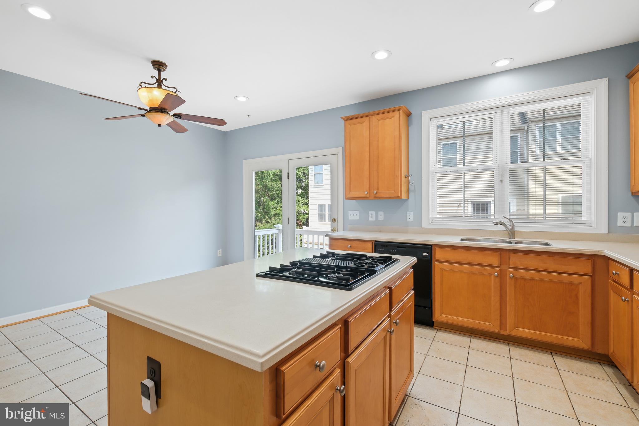 10728 Horde Street Silver Spring, MD 20902 - Photo 10 of 38 a kitchen with a stove a sink dishwasher and a refrigerator