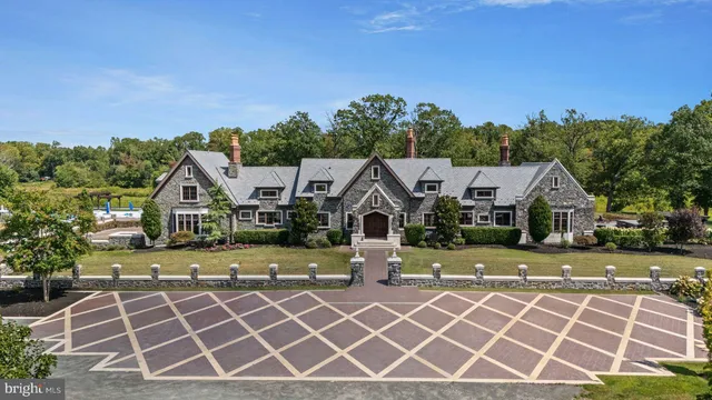 an aerial view of a house with a yard and trampoline