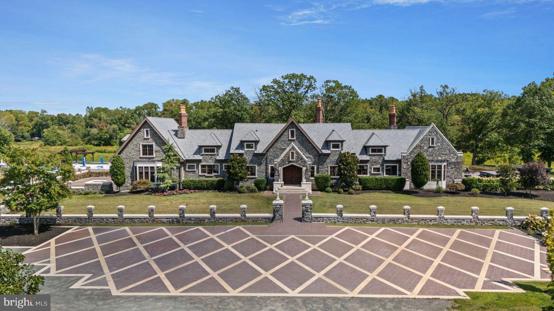 an aerial view of a house with a yard and trampoline