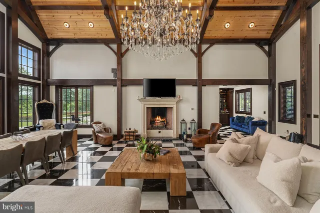 a living room with a couch and a dining table with wooden floor