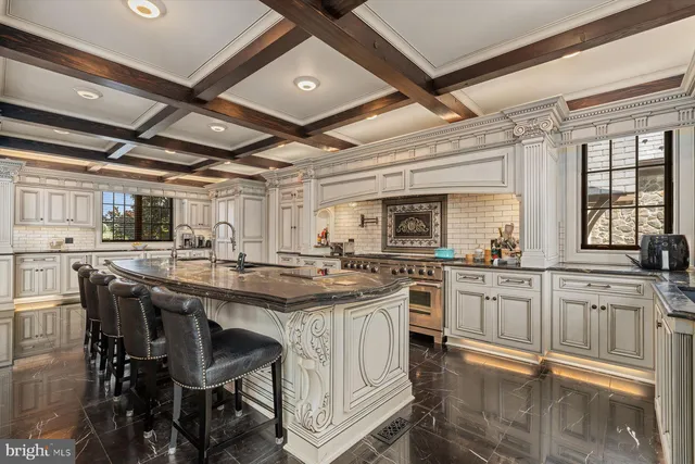 an aerial view of a house with a garden and lake view