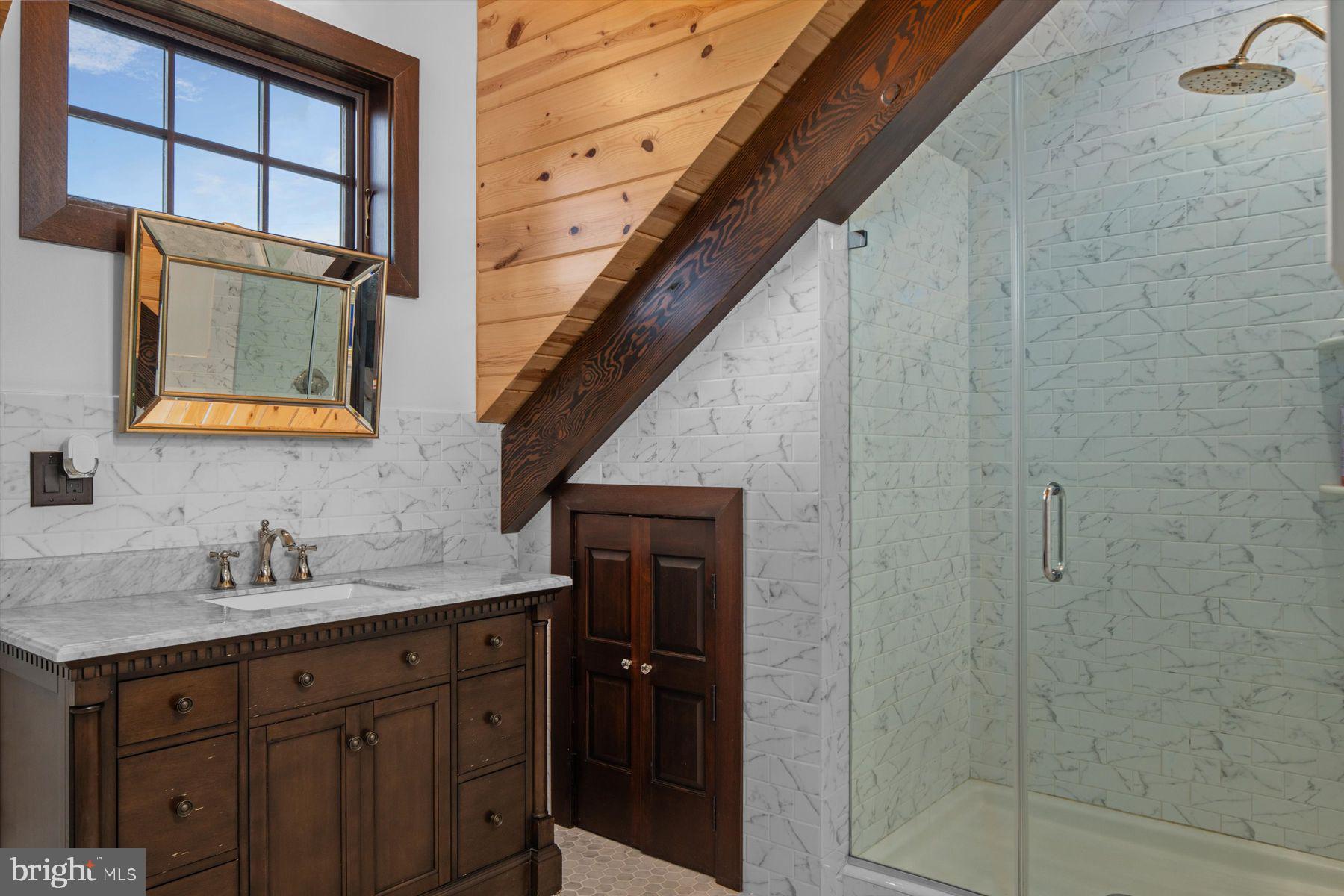 50 Mill Road Swedesboro, NJ 08085 - Photo 44 of 99 a bathroom with a sink a mirror and shower