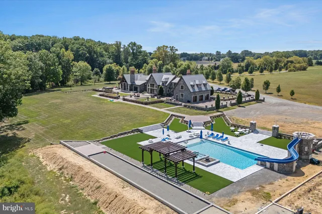 a living room with furniture a large window and a chandelier