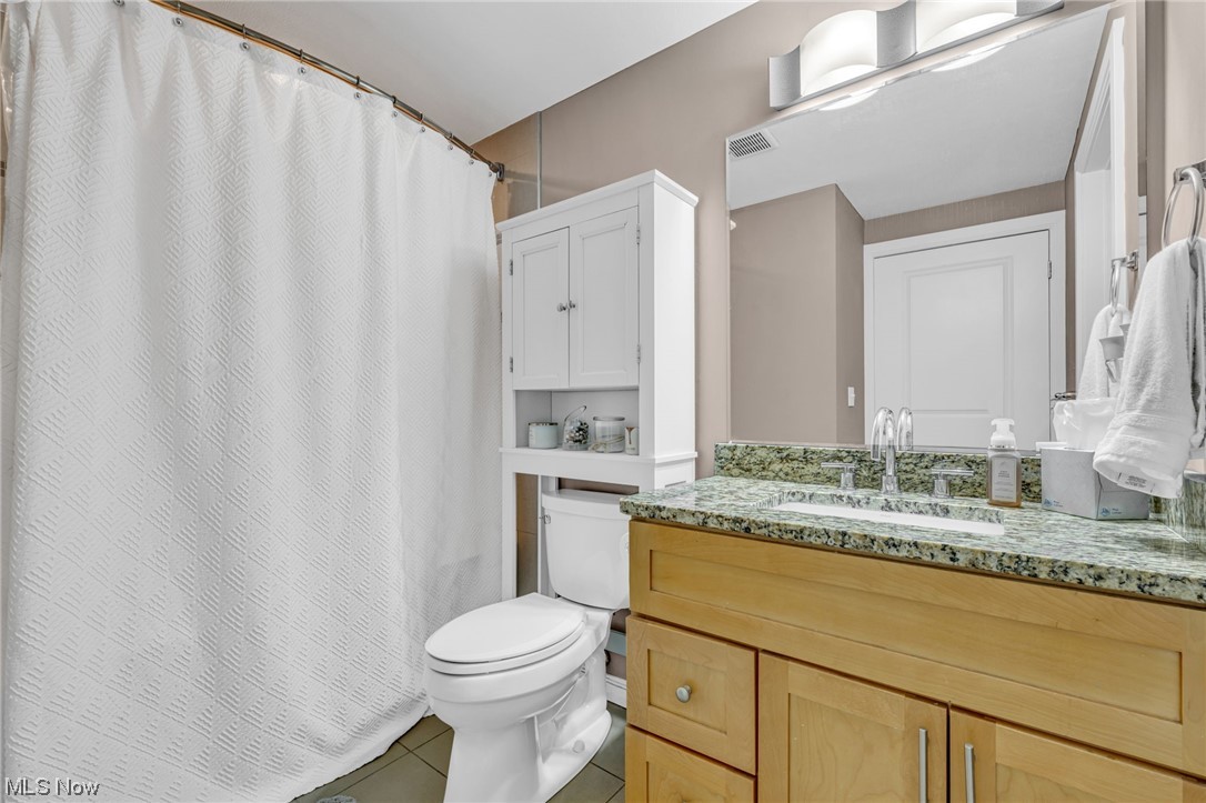 1237 Washington Avenue, Unit 1110 Cleveland, OH 44113 - Photo 17 of 28 Bathroom with light tile flooring, mirror, and large vanity