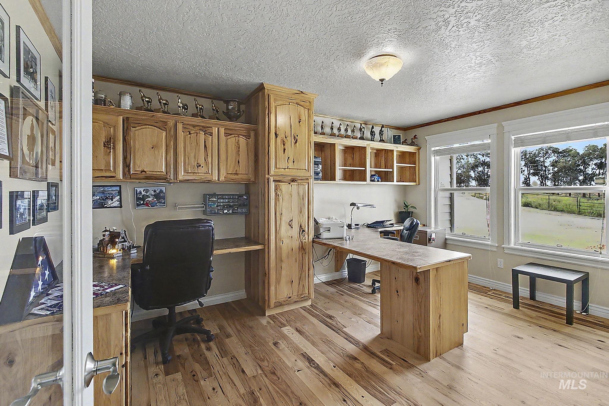 6900 West Charters Lane Melba, ID 83641 - Photo 18 of 49 Wood-finish flooring, built-in wooden cabinetry, recessed lighting, and multiple windows providing natural light