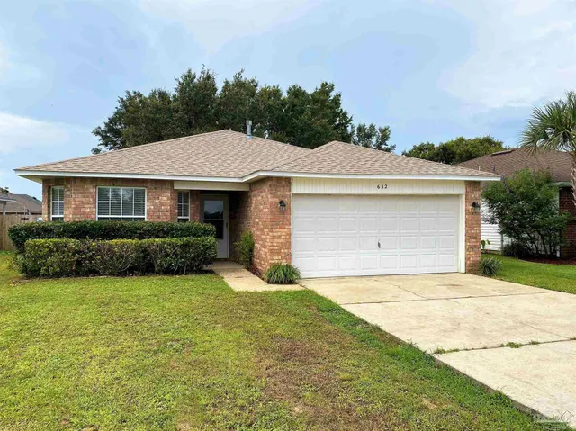 a front view of a house with yard and green space