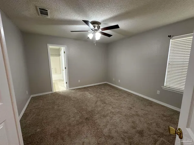 a view of a livingroom with a ceiling fan and window