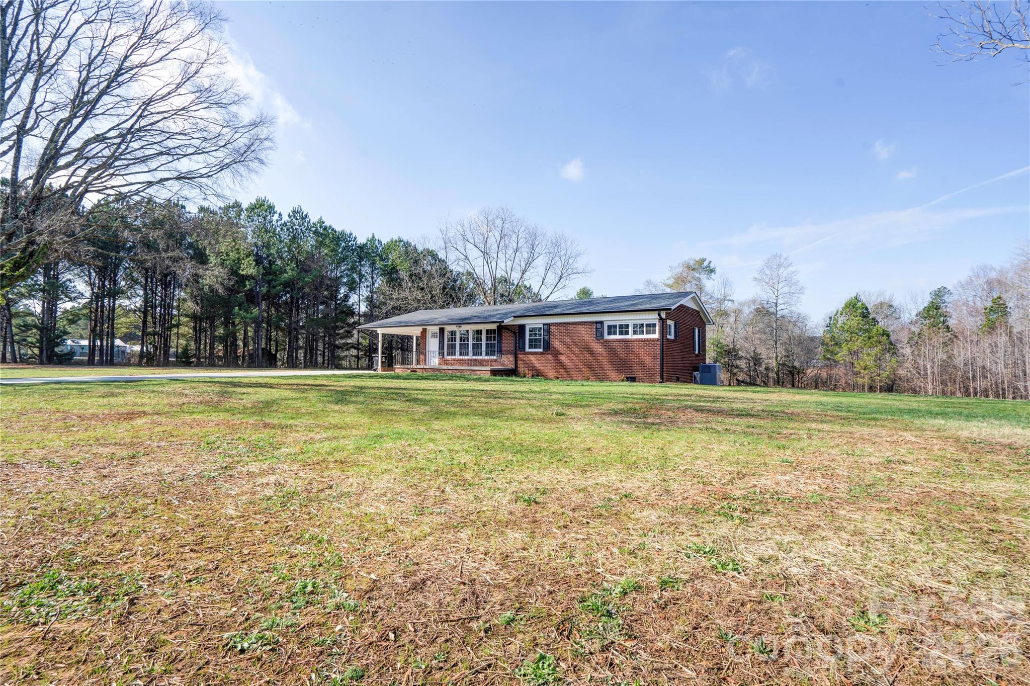 2822 Bettis Road Grover, NC 28073 - Photo 5 of 32 a front view of a house with a garden