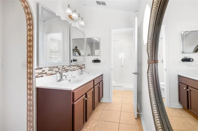 a bathroom with a sink a mirror and a shower