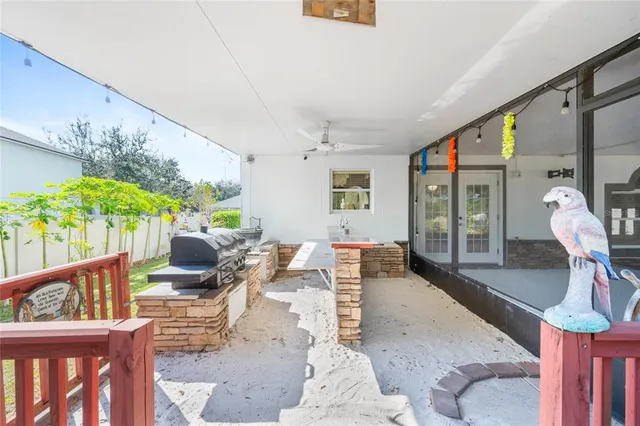 a living room with furniture potted plant and a large window