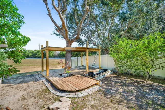 a view of a house with backyard and sitting area