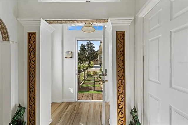 a view of a hallway with wooden floor and a entryway