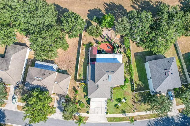 an aerial view of a house with garden space and street view