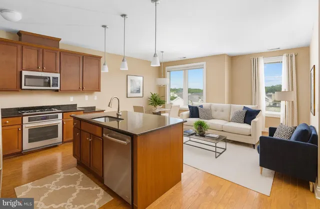 a kitchen with stainless steel appliances granite countertop a sink stove and microwave