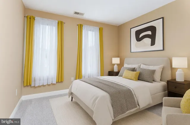 a bedroom with a bed and a painting on the wall