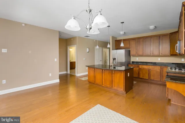 a large kitchen with stainless steel appliances granite countertop a granite counter tops and a stove