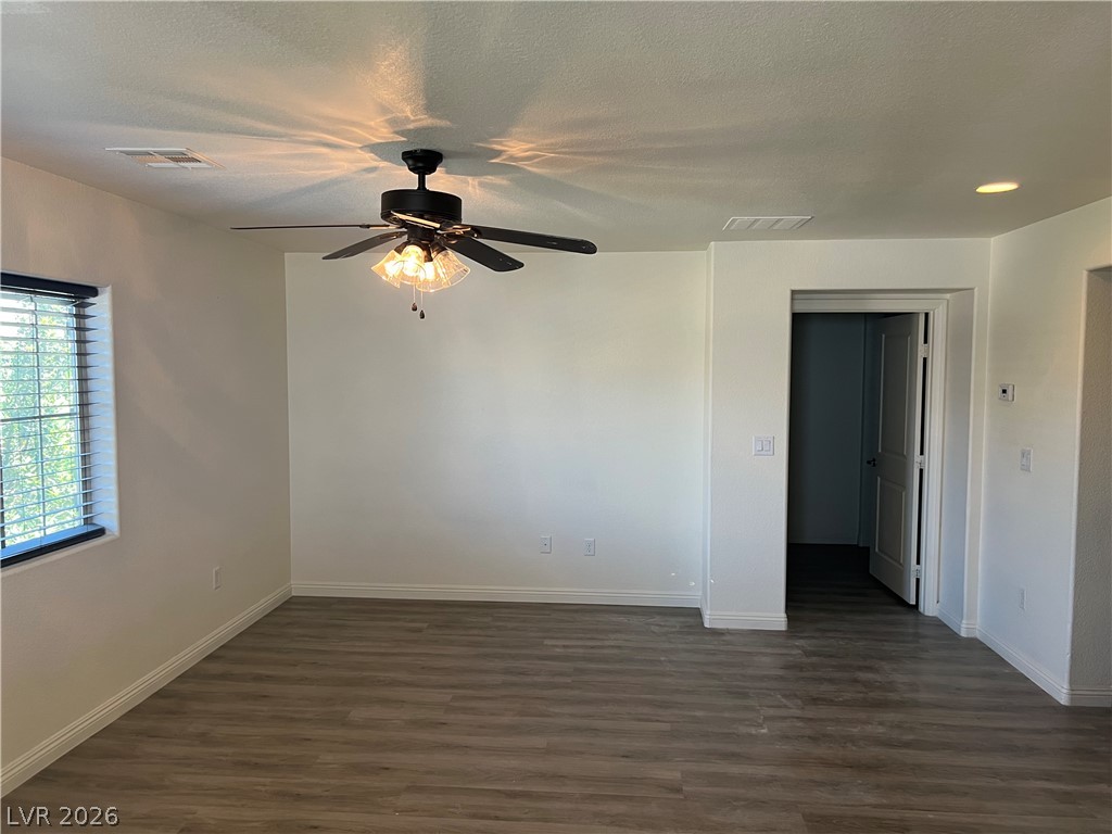 9581 Aberdeen Ridge Court Las Vegas, NV 89148 - Photo 14 of 25 Wood plank flooring and a ceiling fan with integrated lighting create a comfortable living space.