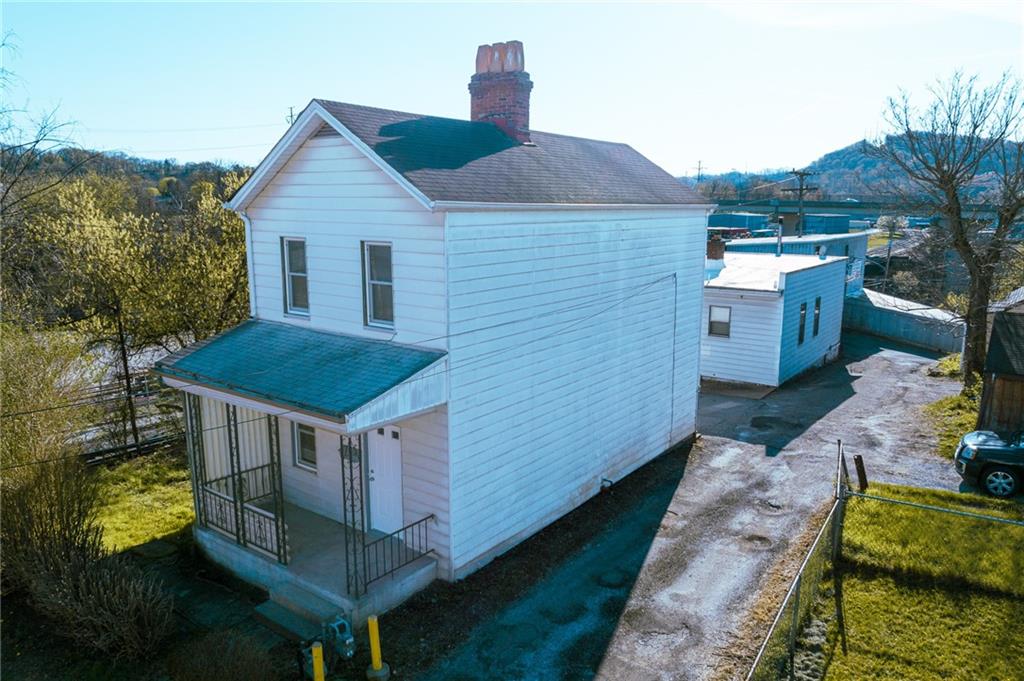 a aerial view of a house with a yard and balcony