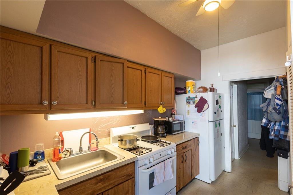 3 Alice Street McKees Rocks, PA 15136 - Photo 11 of 25 a kitchen with a sink stove and refrigerator