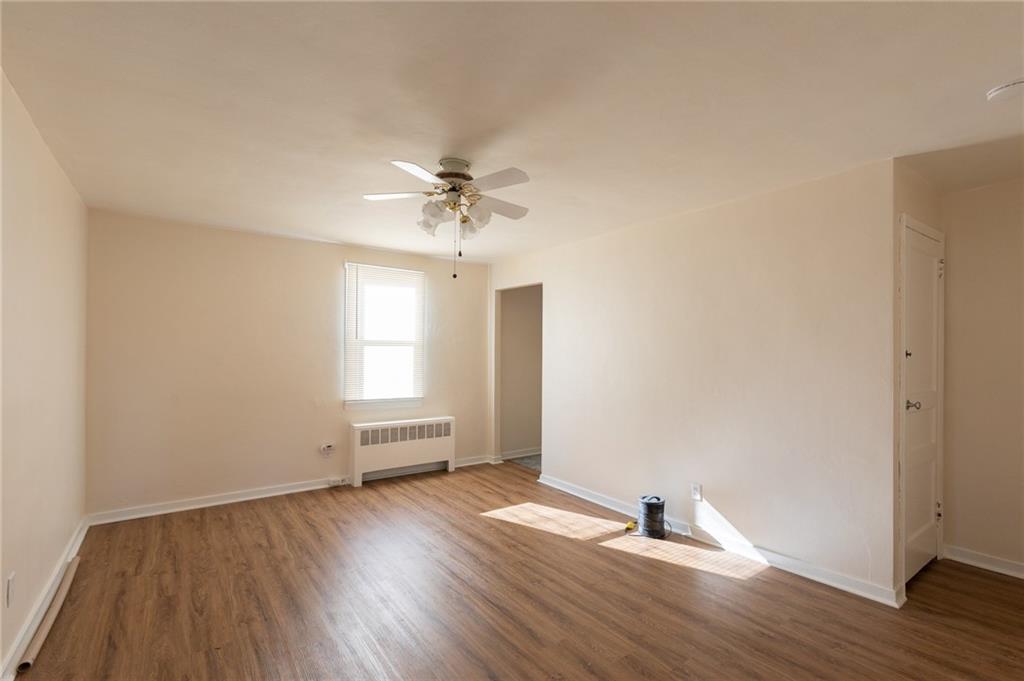 3 Alice Street McKees Rocks, PA 15136 - Photo 19 of 25 a view of empty room with wooden floor and fan