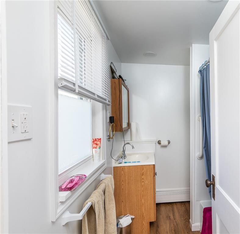 3 Alice Street McKees Rocks, PA 15136 - Photo 23 of 25 a bathroom with a granite countertop sink and a mirror
