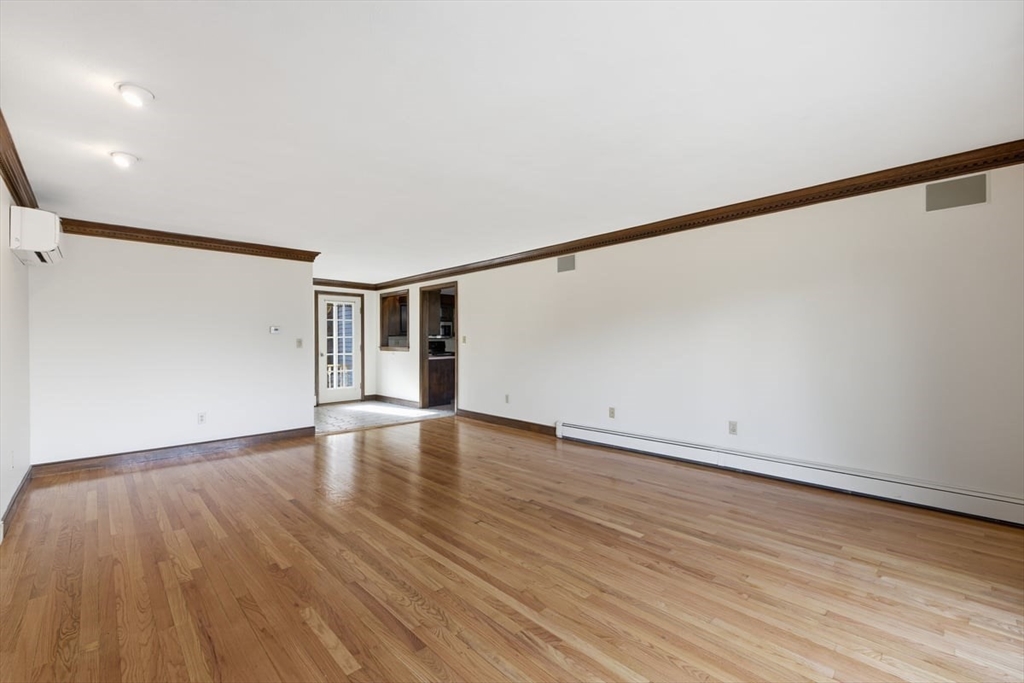 64 Village Street Millis, MA 02054 - Photo 11 of 41 a view of an empty room with wooden floor and a window