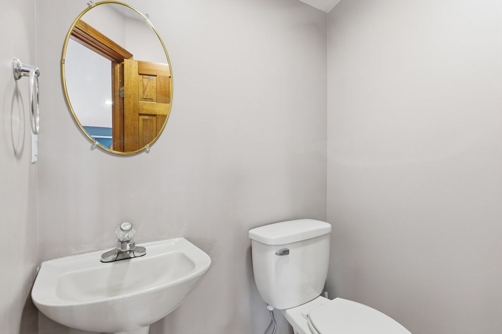 64 Village Street Millis, MA 02054 - Photo 19 of 41 a bathroom with a toilet a sink and a mirror